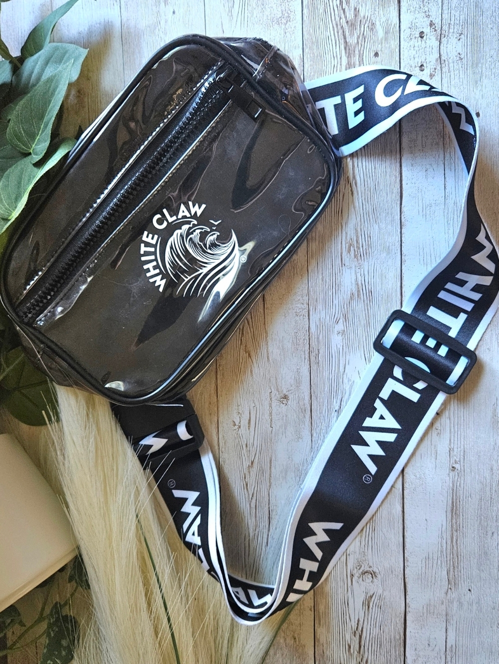 White Claw branded clear and black belt bag, commonly used as a stadium-approved